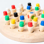 Wooden memory board with colored pegs and a color die; supplier close-up